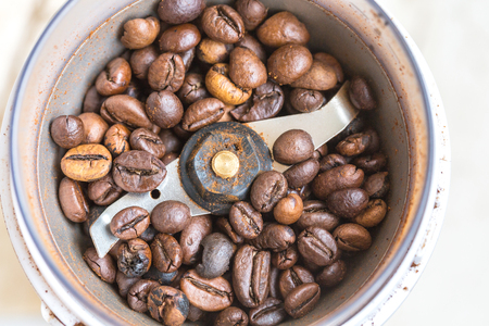 Fried coffee beans in a coffee grinder. Macro Vintage toningの写真素材