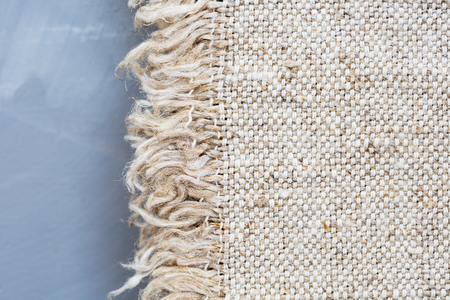 Fabric sackcloth texture on a gray background.Burlap texture. Pattern fabric textile.の写真素材