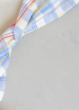 Striped blue towel in red and yellow stripes on a gray backgroundの写真素材