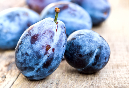 Fresh ripe plums on a wooden backgroundの写真素材
