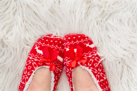 New Year's, Christmas slippers for adults are dressed for the women. On white soft fur. Funny, funny, humorous, cozy,の写真素材