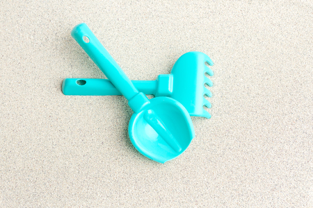Sea sand, blue toys for sand, shovel, rake.の写真素材