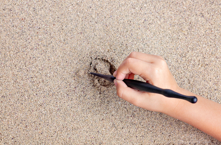 Child draws a stick on the sea with the sun. Children's drawing.の写真素材