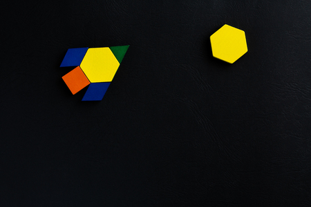The space ship flies into space to another new planet. Summer happy atmosphere. A child plays with colored blocks constructs a model on a black backgroundの写真素材