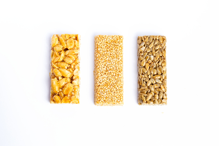 Granola bar. Healthy sweet dessert snack. Sesame, hazelnut, sunflower in honey. Gozinaki is Georgian national food, oriental sweet. Top viewの写真素材