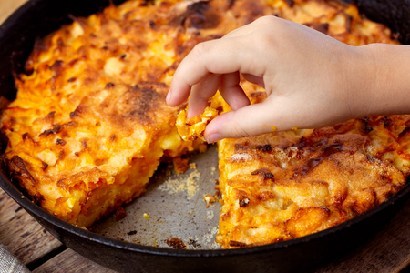 Childrens hand takes a piece of pumpkin pie.の写真素材
