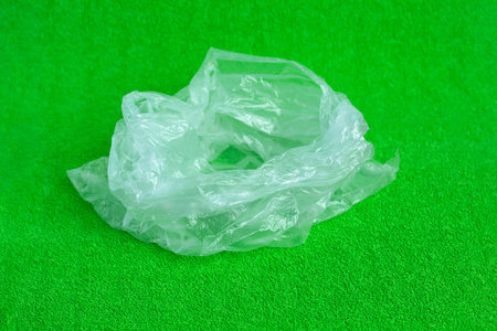 Open plastic bag on greens background. Environmental Protection.