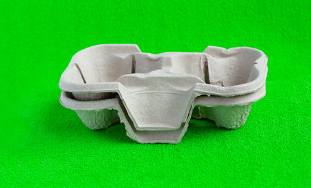 Two paper cups with takeaway drinks. Isolated on green