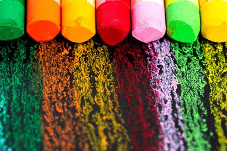 Crumbs and chunks of multicolored chalk, Oil pestel on white paper for watercolor. Yellow, pink, red, green, gray, light green crimson.の写真素材