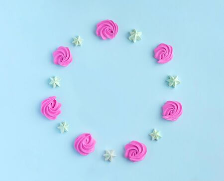 Circle of little meringues in pastel colors on a pink background. Valentine, Moms Day,の写真素材