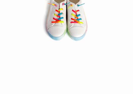 Close up running shoes with rainbow laces for the child on a isolated backgroun. Top view.の写真素材