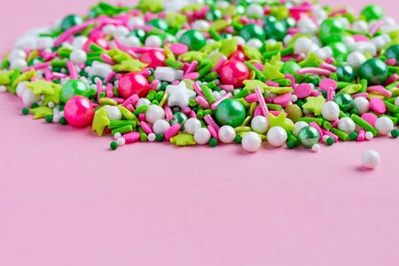 Multi-colored Sugar sprinkle dots, decoration for cake on pinkの写真素材
