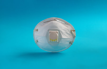 World Coronavirus 2019-ncov attack concept. White medical mask on blue