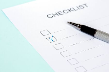 Close-up of on Checklist with pen on a blue background.の写真素材