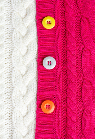 Knitted sweaters white and red and multi-colored buttons. Textures