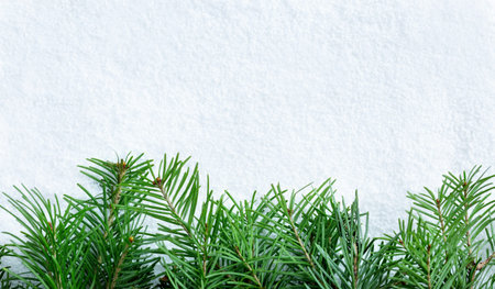 A transparent ball with a garland glows with a yellow light and lies on the snow