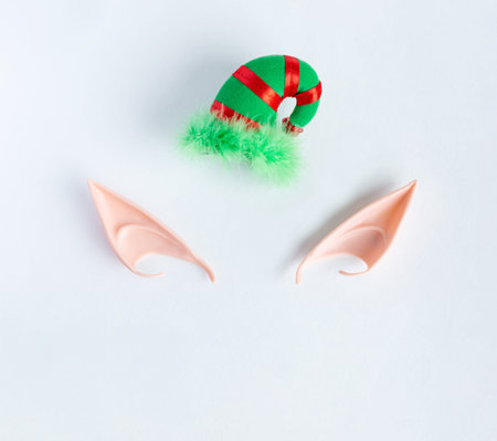 Elf ears and hat on a gray background. Christmas and magic concept.