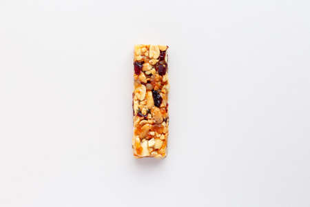 Granola bar. Healthy sweet dessert snack. Sesame, hazelnut, sunflower, cranberries, dry berries, in honey. Top viewの写真素材
