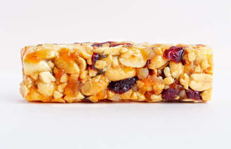 Granola bar. Healthy sweet dessert snack. Sesame, hazelnut, sunflower, cranberries, dry berries, in honey. Top viewの写真素材