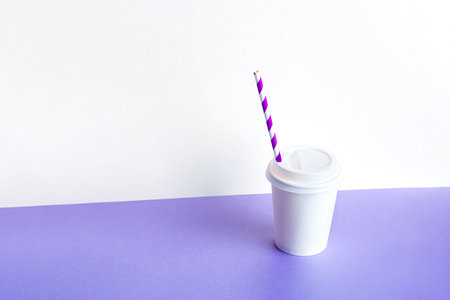 Plastic Coffee glass with a straw on a lilac background. Takeaway,の写真素材