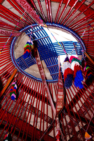 The upper part of the traditional Kazakh yurt inside is decorated with colorful tassels. House of nomadsの写真素材