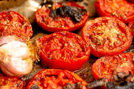 Baked tomatoes with garlic and spices for sauce. Appetizing photo. Macroの写真素材