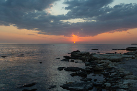 Rocky sea shore in rays of sunset sky. Caspian Sea Kazakhstanの写真素材