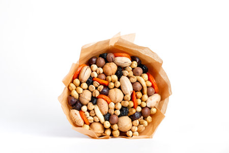 An edible bouquet of dried fruits and nuts on white background.の写真素材
