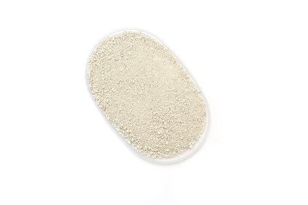 Transparent container holds fine white small granules of cat litter, emphasizing a clean aesthetic and functional design, suitable for storage and organization in various settings Pet care. View from aboveの写真素材