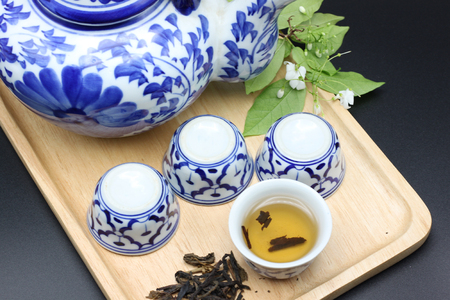 Traditional Ceramic Teapot and Cups on Wooden Trayの写真素材