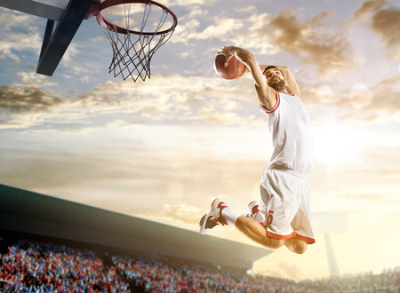 Basketball player in action on background of sky and crowdの写真素材