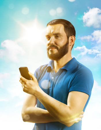 Young man smile and holding a phoneの写真素材