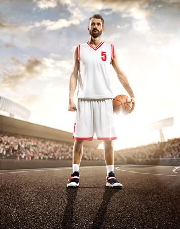 Basketball player in action on background of sky and crowdの写真素材