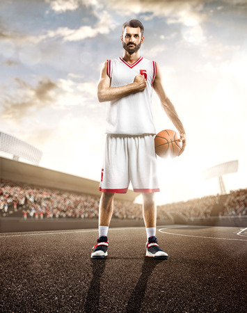 Basketball player in action on background of sky and crowdの写真素材