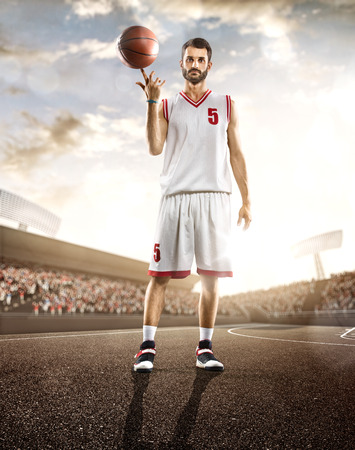 Basketball player in action on background of sky and crowdの写真素材