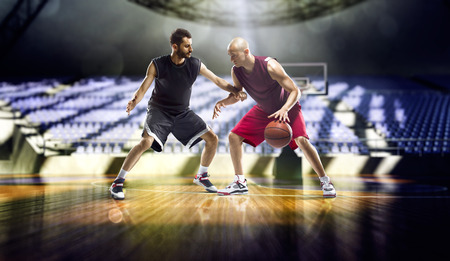 Two basketball players action in the city gymの写真素材