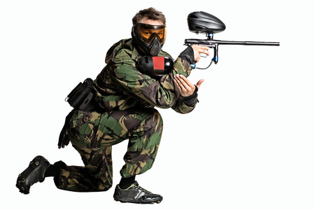 Isolated on white painball player in actionの写真素材