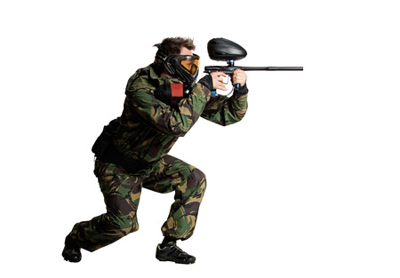 Isolated on white painball player in actionの写真素材
