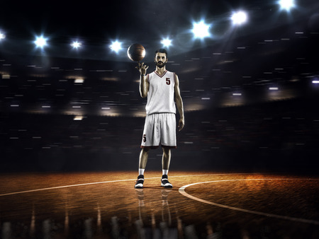 Basketball player is spinning ball on the finger in gymの写真素材