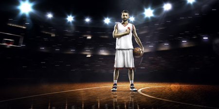 Basketball player is spinning ball on the finger in gymの写真素材