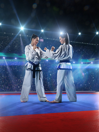 Two professional female karate fighters are fighting on the grand arenaの写真素材