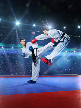 Two professional female karate fighters are fighting on the grand arenaの写真素材