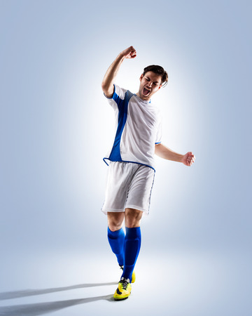 football soccer player in action  isolated on color backgroundの写真素材
