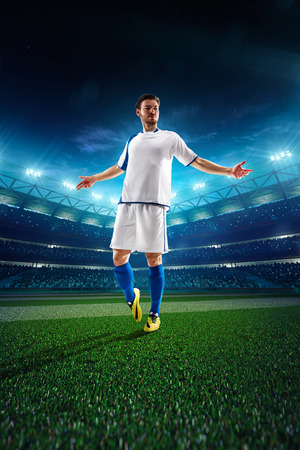 Soccer player in action on night stadium backgroundの写真素材