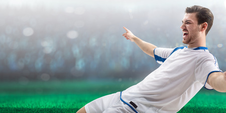 Soccer player in action on night stadium backgroundの写真素材