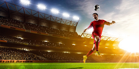 Soccer player in action on night stadium background panoramaの写真素材