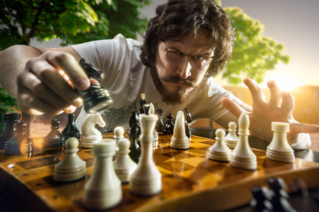 Very serious man is playing the chess