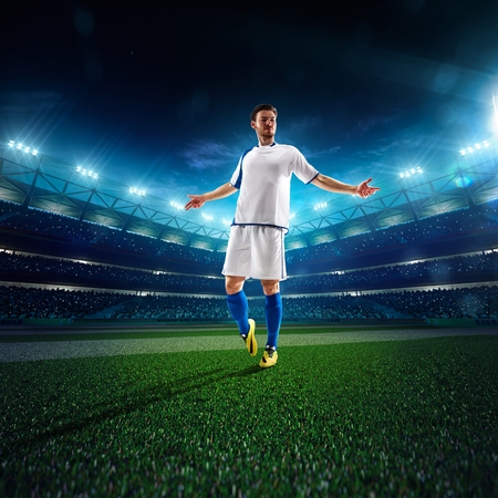 Soccer player in action on night stadium panorama backgroundの写真素材