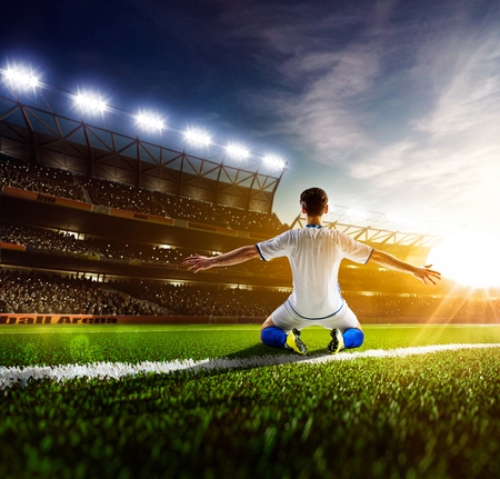 Soccer player in action on night stadium panorama backgroundの写真素材