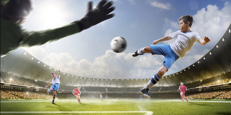 Childrens are playing soccer on grand arena in sunlightsの写真素材
